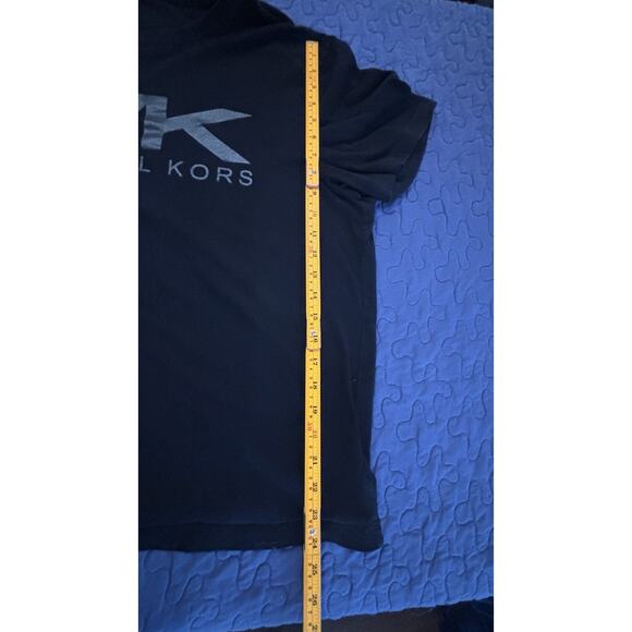 Michael Kors black t-shirt featuring a large, vertical metallic silver logo. - Picture 6 of 7